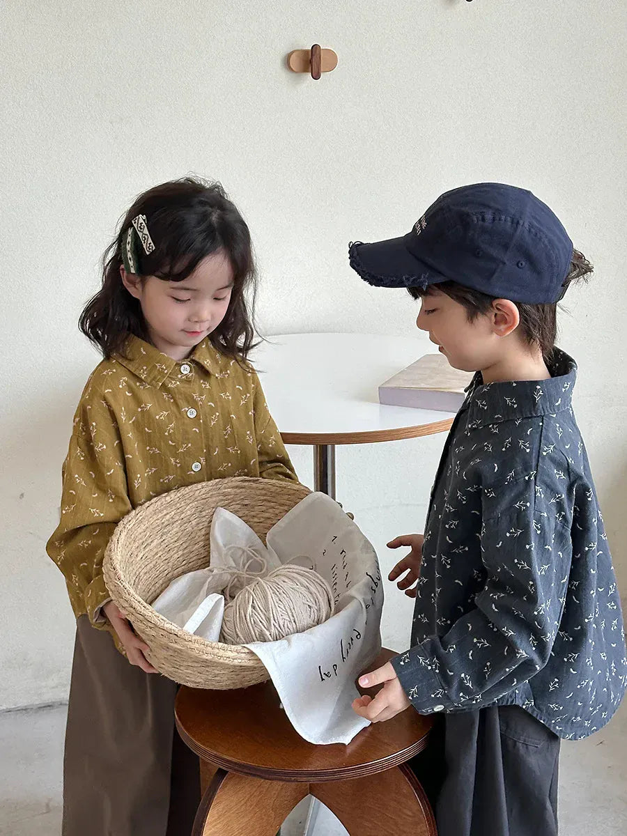 小花柄プリントの長袖ボタンシャツ。からし色と紺色のキッズトップス。
