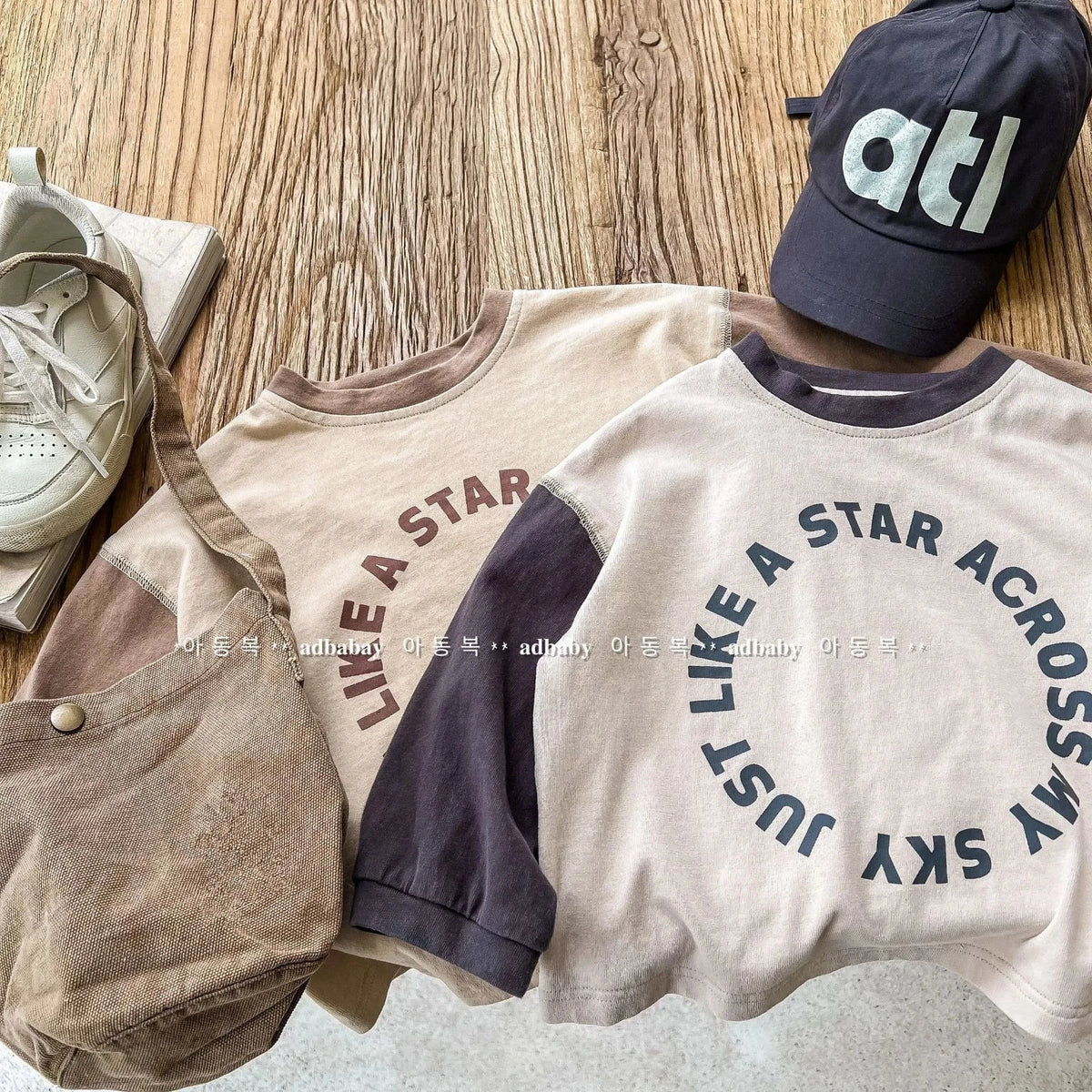 キッズ用バイカラー長袖Tシャツ、ベージュ前面とネイビーのラグラン袖、ロゴ入り