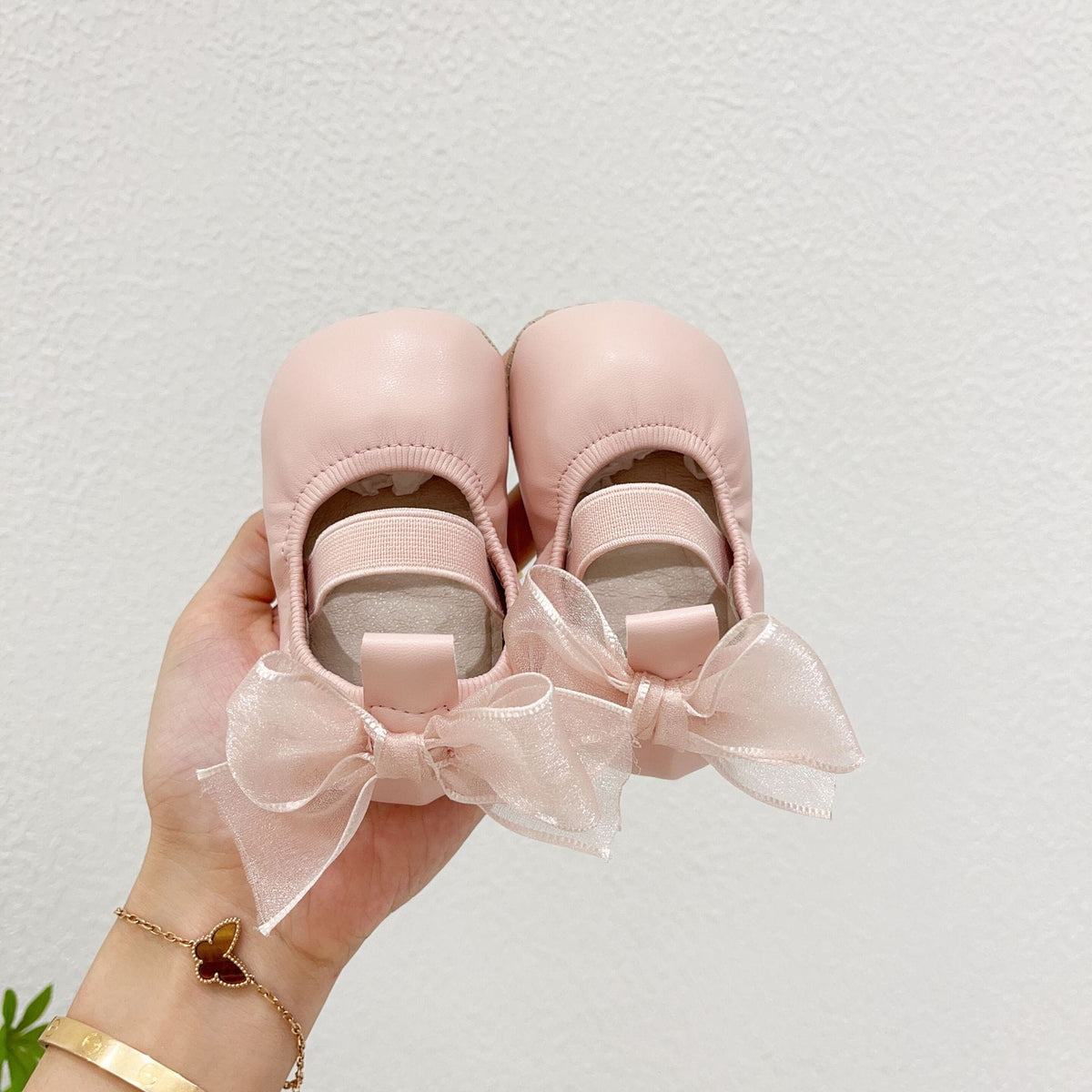ピンクのベビー室内シューズ(リボン付き、バックルストラップ風)