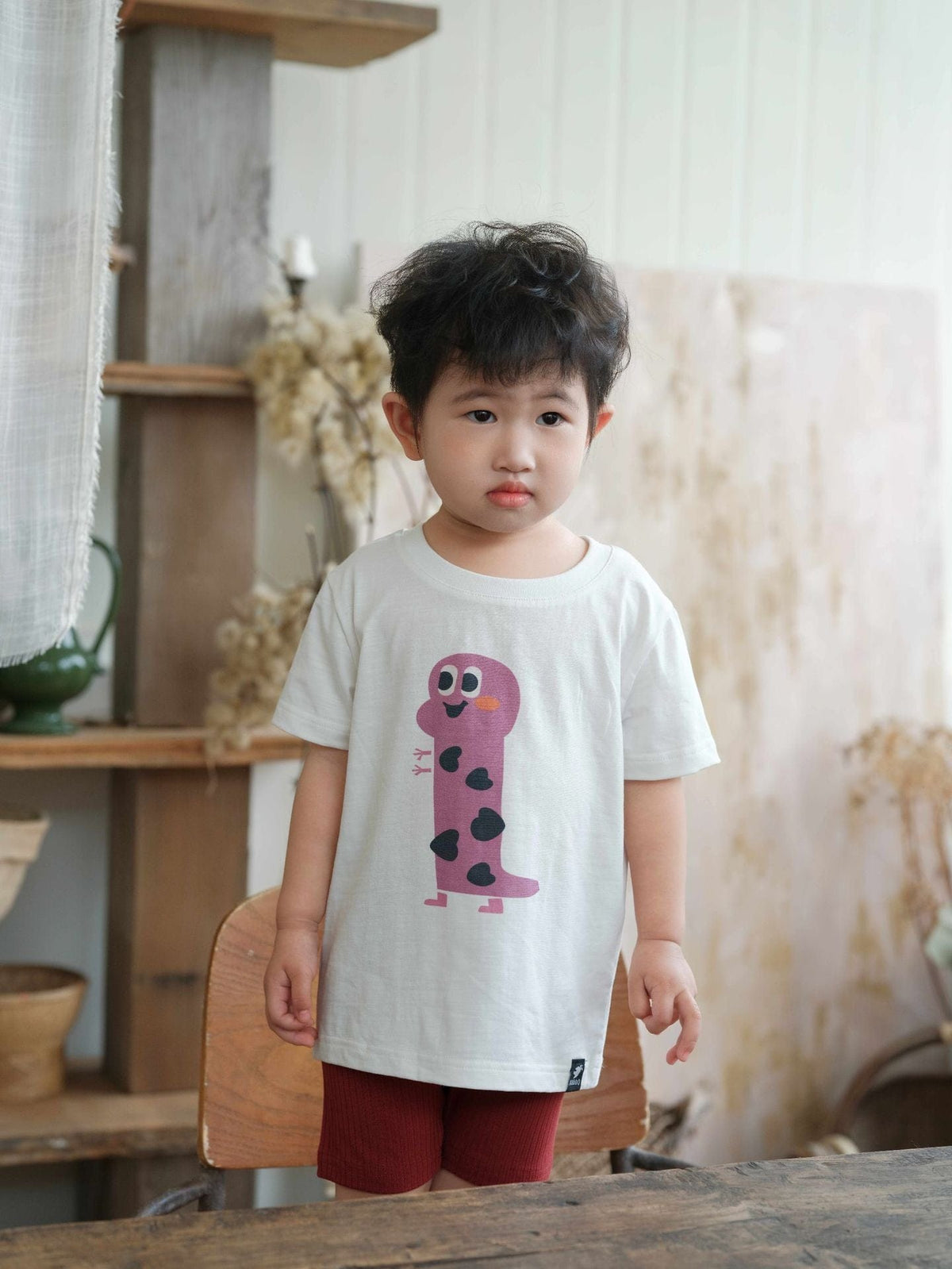白の半袖Tシャツ、フロントにピンクのキャラクタープリント