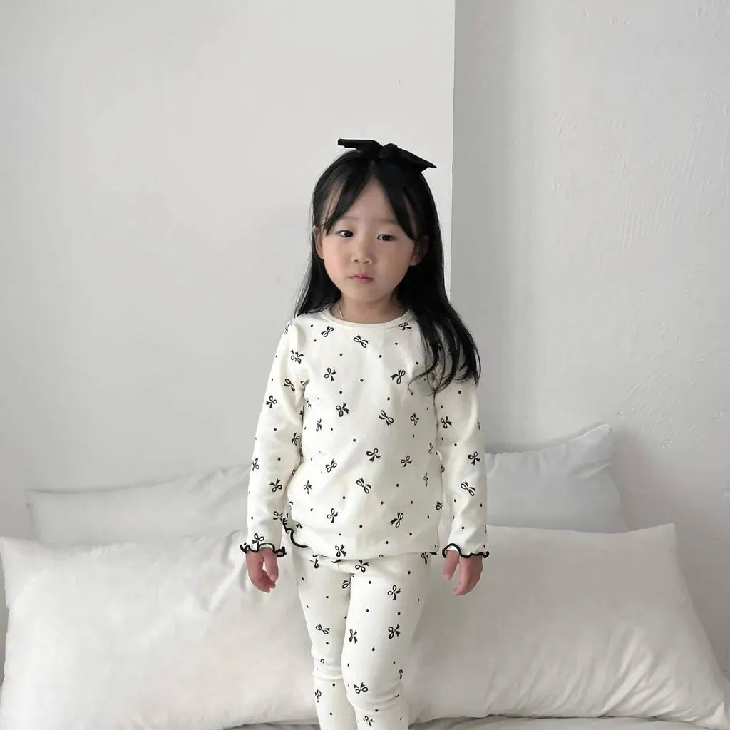 リボン柄の子ども用パジャマセット、長袖トップスとロングパンツ