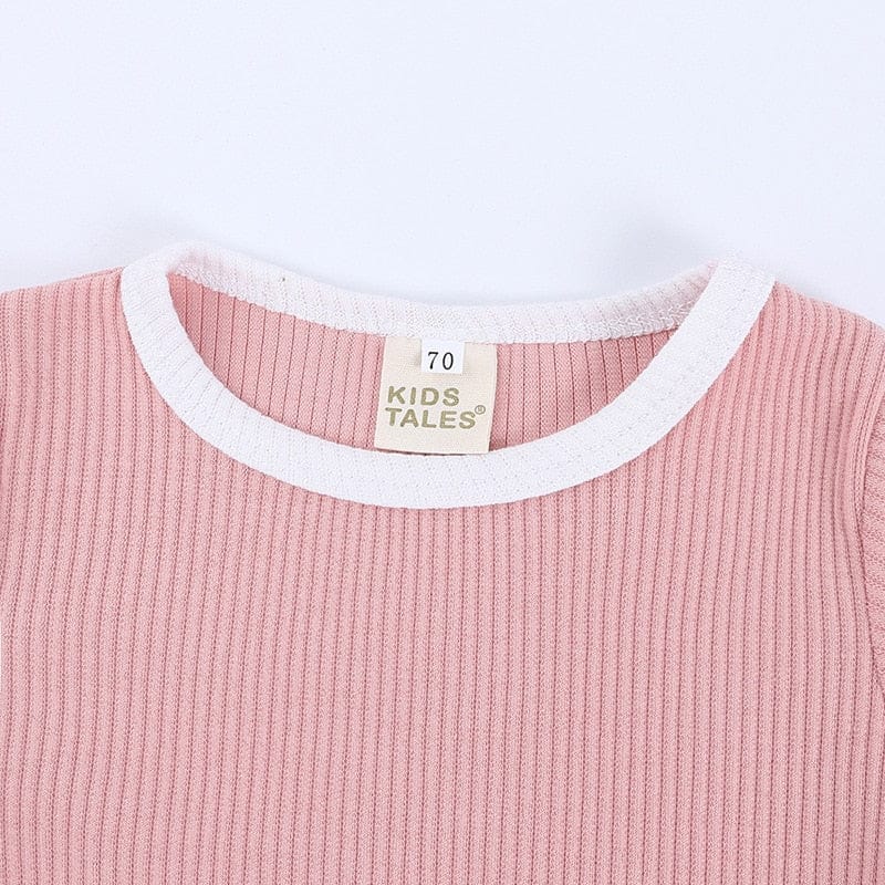 ピンクのリブ半袖Tシャツ、白いパイピングの首まわり