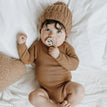 brown bodysuit + hat