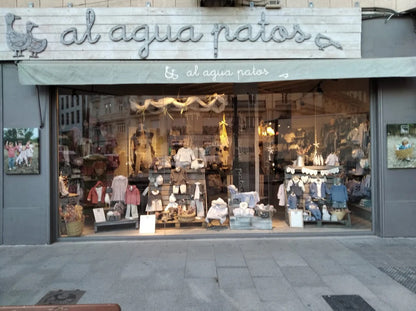 店舗のショーウィンドウと看板「al agua patos」