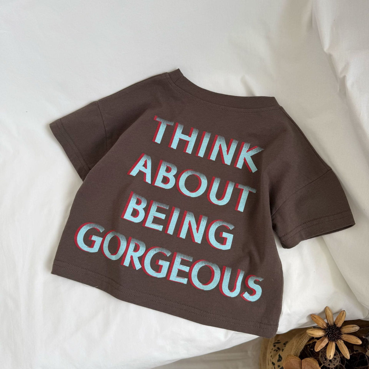 ダークブラウンの綿半袖Tシャツ、背面ロゴプリント『THINK ABOUT BEING GORGEOUS』