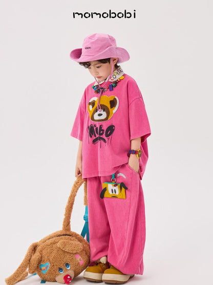 ピンクの半袖Tシャツ＆ワイドパンツセット。フロントにアライグマプリント