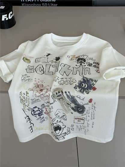 クリーム色の半袖クルーネックTシャツ、落書き風グラフィックプリント