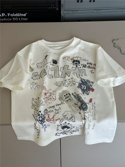 クリーム色半袖Tシャツ、落書き風文字とロボット風イラストのプリント