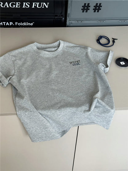 ライトグレーの無地風英字プリント半袖Tシャツ、フロントに小さなロゴ