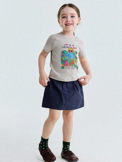 子ども用ラグランTシャツ　ベージュ地のカラフルキャラクタープリント