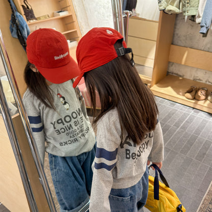 ライトグレー長袖Tシャツ、背面にスヌーピー系プリント