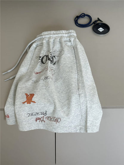 ライトグレー スウェットショートパンツ、背面プリント、サイドポケット風の縫い目