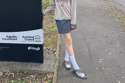 グレー系Tシャツに合わせたダークグレーAラインスカート、膝上丈