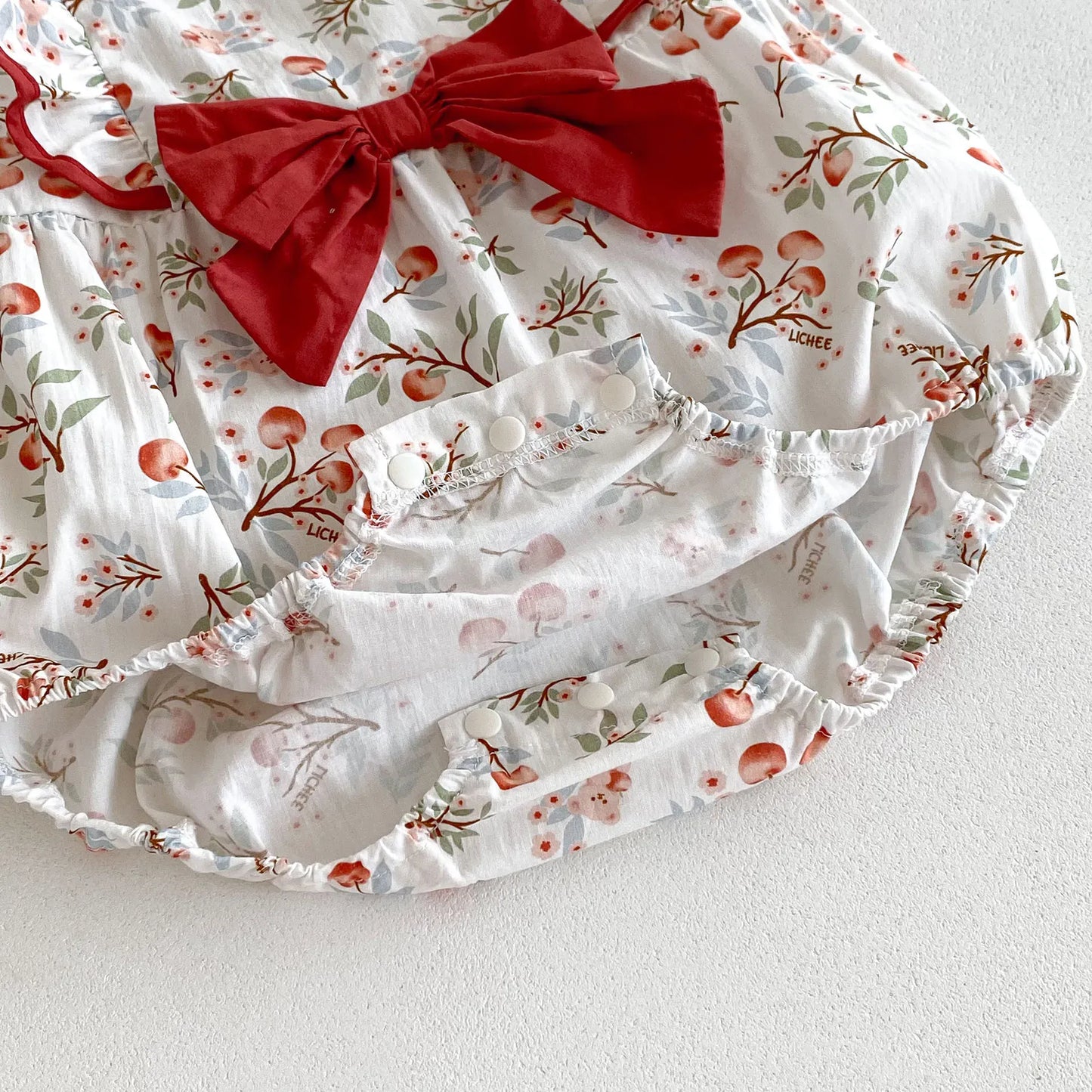 ノースリーブロンパース ベビーロンパース ヘアバンドセット ノースリーブリボンフリルボディスーツ