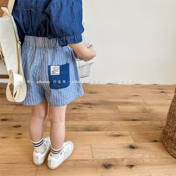キッズが着用するストライプラップ風ショートパンツ（ブルー）濃色ポケット付き