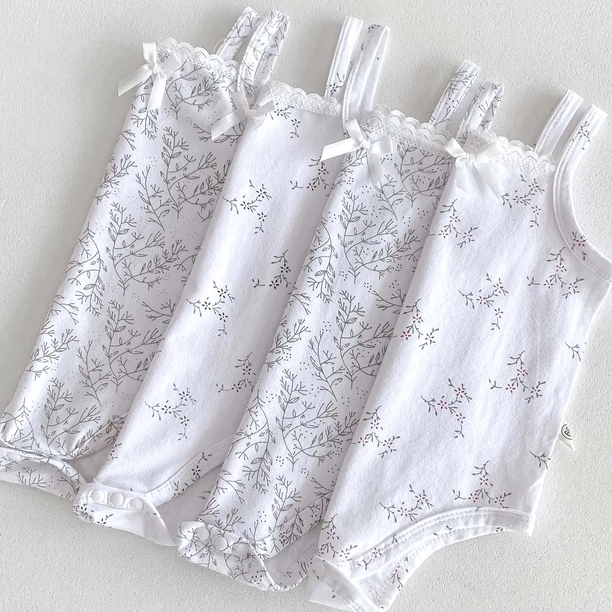 ノースリーブロンパース ベビーロンパース キャミソールボディスーツ リボン ボタニカルプリント柄 肌着【mh0005701】