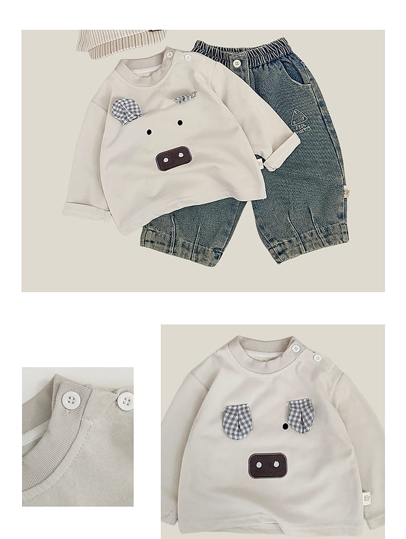 長袖Tシャツ オフホワイト系、胸のチェック柄と濃色モチーフ、前スナップ付き